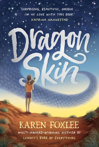 A girl stands with a dragon on her shoulder in the desert. A dragon tail is in front of her in the blue sky. The title is Dragon Skin. The author is Karen Foxlee.