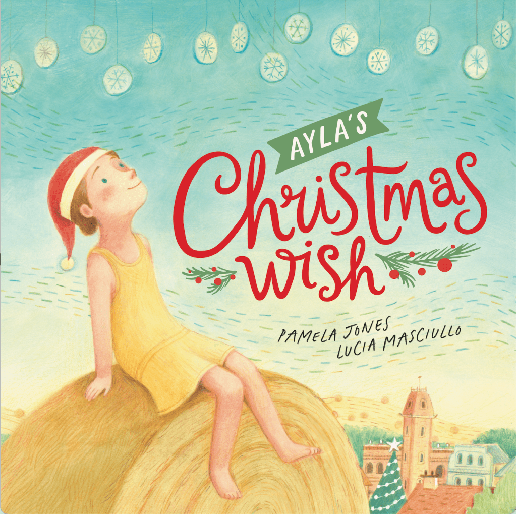 A young girl in a yellow dress and a Santa hat is sitting on a hay bale looking up at hanging snowflake decorations, with the town and a Christmas tree below her. Text reads Ayla's Christmas Wish by Pamela Jones and Lucia Masciullo.