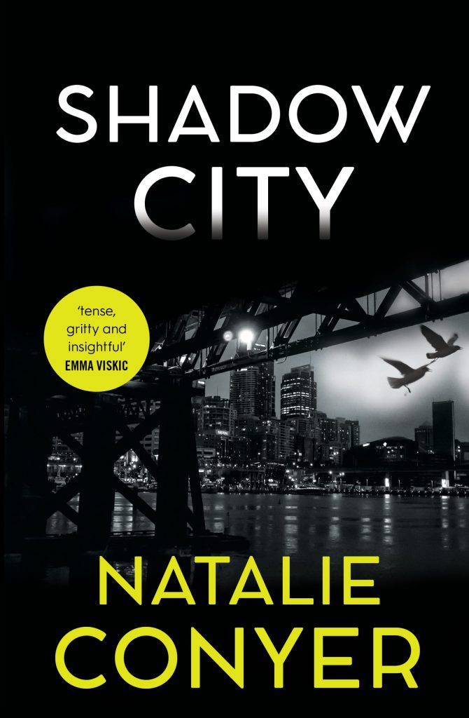Shadow City A black and white photo of Sydney from under the Harbour Bridge with green and white text. The white text says Shadow City and the green text says Natalie Conyer.