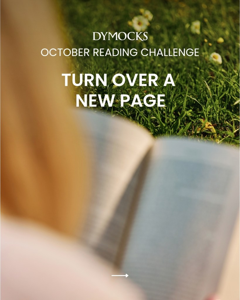 An out of focus person and book sitting on grass. White text says Dymocks Reading October Challenge and Turn Over A New Page. 

